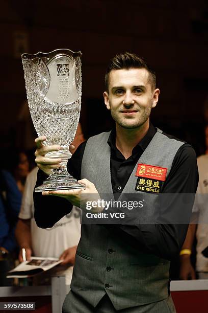 Mark Selby of England celebrates with the trophy after winning the final match against Tom Ford of England on day 4 of the Paul Hunter Classic 2016...