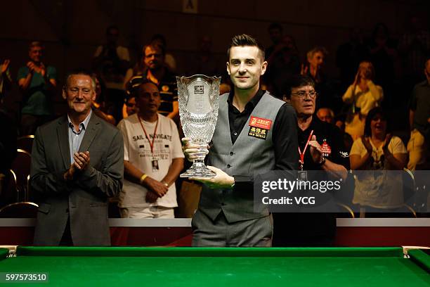 Mark Selby of England celebrates with the trophy after winning the final match against Tom Ford of England on day 4 of the Paul Hunter Classic 2016...