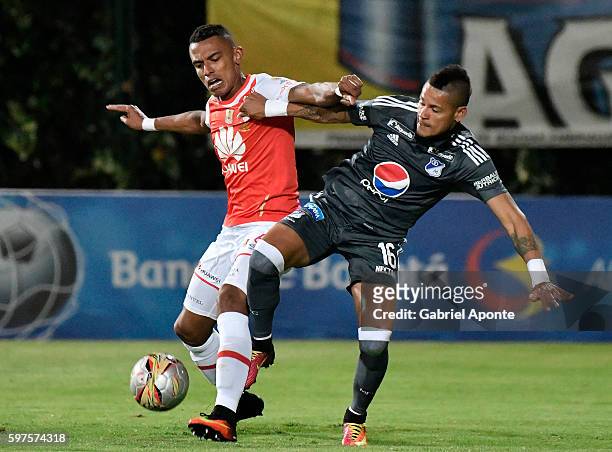 William Tesillo of Santa Fe struggles for the ball with Ayron del Valle of Millonarios during a match between Independiente Santa Fe and Millonarios...