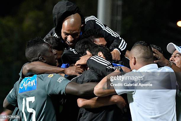 Enzo Gutierrez of Millonarios celebrates with teammates after scoring the second goal of his team during a match between Independiente Santa Fe and...