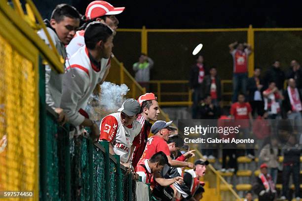 Fans of Santa Fe cheer for their team during a match between Independiente Santa Fe and Millonarios as part of round 10 of Liga Aguila 2016 at...