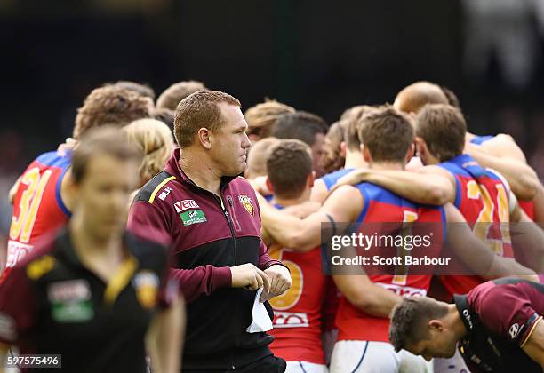 Lions head coach Justin Leppitsch leaves the field after speaking to his team for the last time during the round 23 AFL match between the St Kilda...