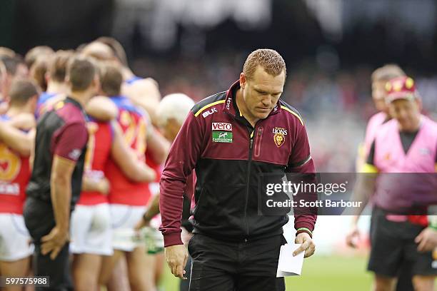 Lions head coach Justin Leppitsch leaves the field after speaking to his team for the last time during the round 23 AFL match between the St Kilda...