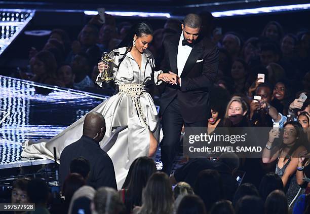 Drake escorts Rihanna after presenting her with The Video Vanguard Award during the 2016 MTV Video Music Awards at the Madison Square Garden in New...