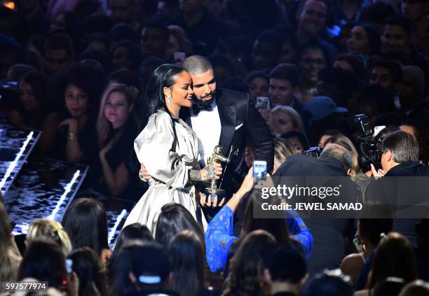 Drake escorts Rihanna after presenting her with The Video Vanguard Award during the 2016 MTV Video Music Awards at the Madison Square Garden in New...
