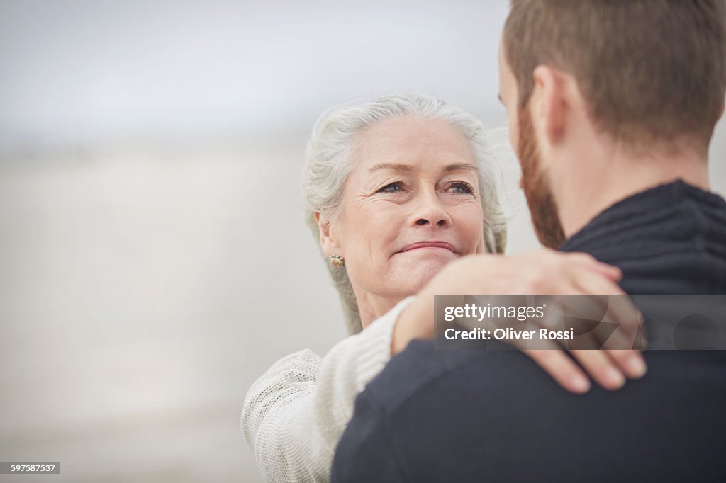 Senior woman looking at adult son
