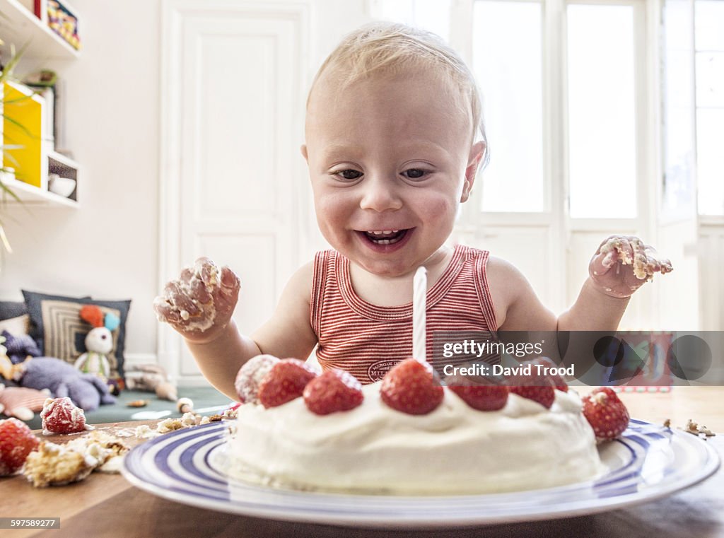 Baby boy with his first birthday cake