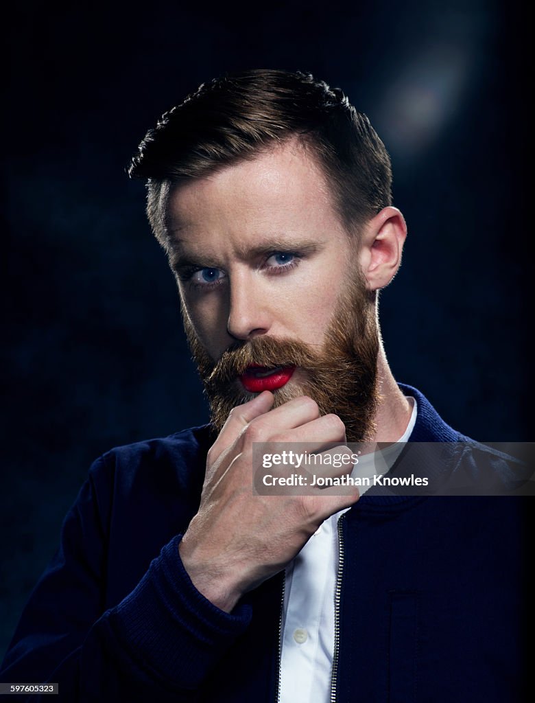 Man with beard and moustache in make up, posing