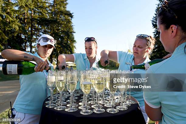 The staff pours sparkling wine in preparation to the ceremony awarding PGA tour cards to 25 players after the final round of the WinCo Foods Portland...