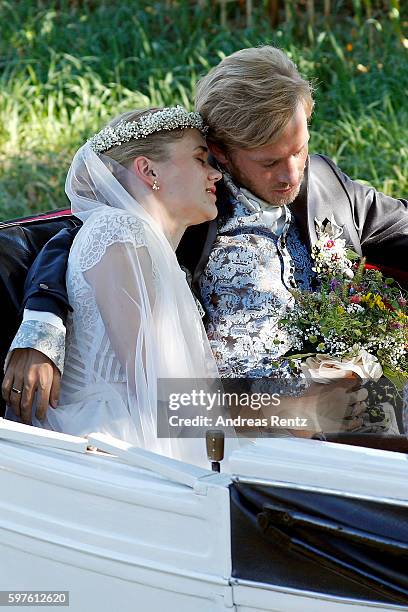 Bridal pair Samuel Koch and Sarah Elena Timpe get photos taken while they ride a carriage after the wedding at the local church to go to their party...