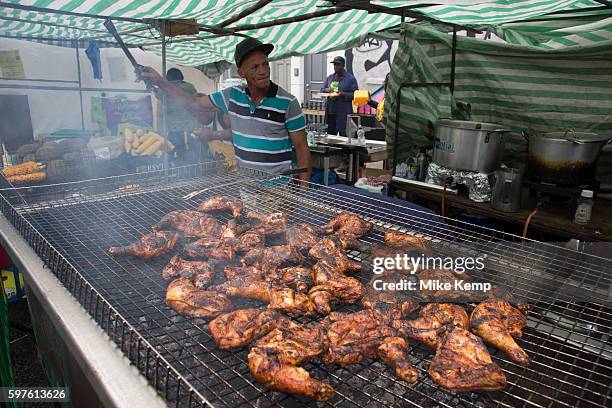 Cooking jerk chicken on Sunday 28th August 2016 at the 50th Notting Hill Carnival in West London. A celebration of West Indian / Caribbean culture...
