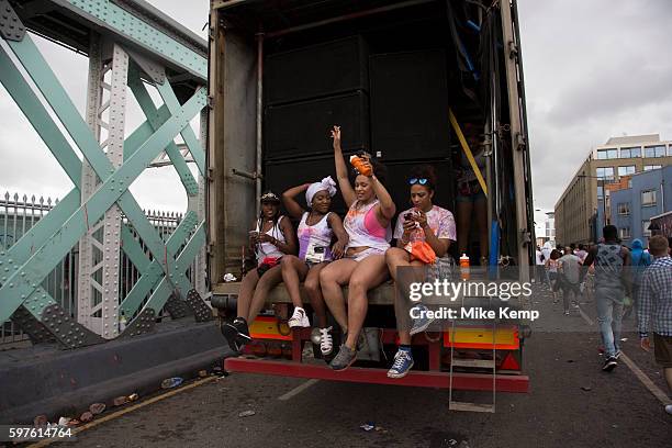 Girls taking a rest on the back of a truck sound system on Sunday 28th August 2016 at the 50th Notting Hill Carnival in West London. A celebration of...