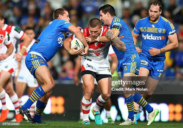 Tariq Sims of the Dragons is tackled during the round 25 NRL match between the Parramatta Eels and the St George Illawarra Dragons at Pirtek Stadium...