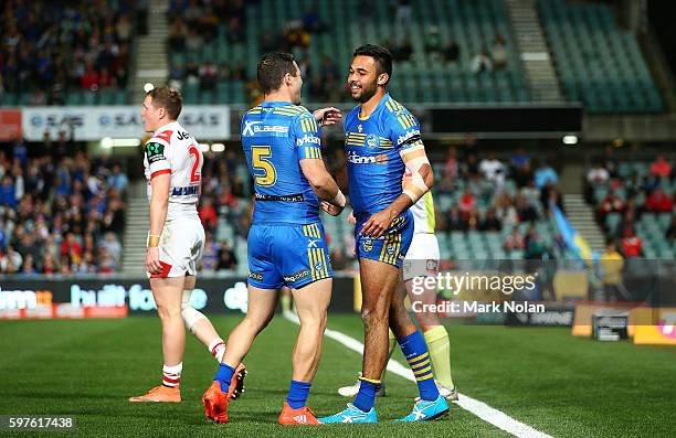 Bevan French of the Eels celebrates one of his tries with team mates during the round 25 NRL match between the Parramatta Eels and the St George...