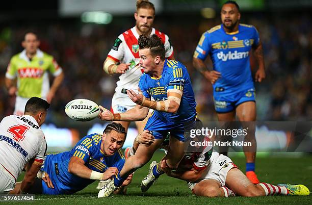 Clinton Gutherson of the Eels offloads during the round 25 NRL match between the Parramatta Eels and the St George Illawarra Dragons at Pirtek...