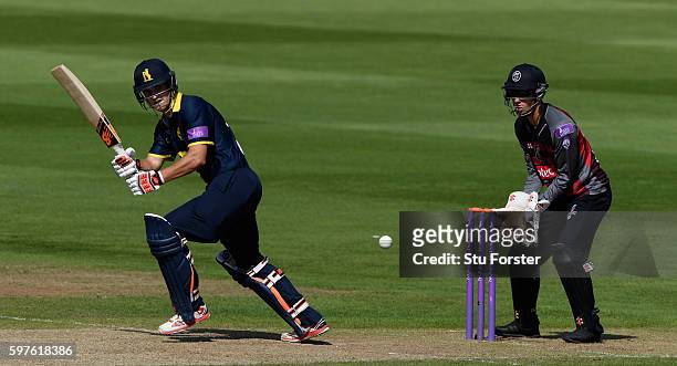 Warwickshire batsman Sam Hain hits out watched by wicketkeeper Ryan Davies during the Royal London One-Day Cup semi final between Warwickshire and...