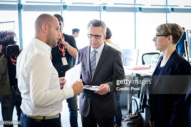 German Interior Minister Thomas de Maiziere tours the Berlin office of Facebook on August 29, 2016 in Berlin, Germany. The German government has put...