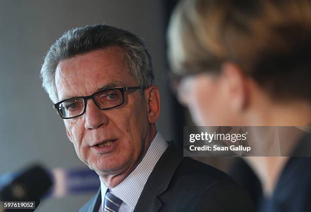 German Interior Minister Thomas de Maiziere and Tina Kulow, Facebook Corporate Communications Director for Northern-Central-Eastern Europe, give...