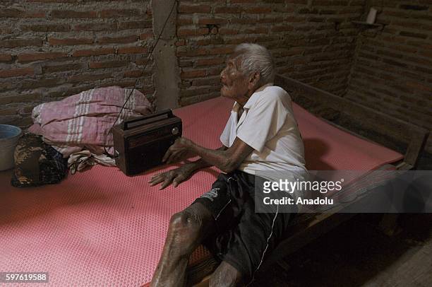 An Indonesian man, named Mbah Gotho, claimed to be 146 years old, is the oldest human in world's history turns on his radio during speaking to press...