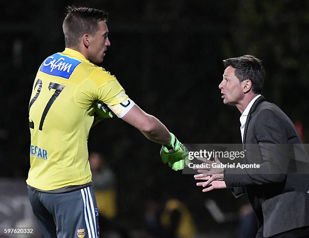 Diego Cocca coach of Millonarios gives directions to his player Nikolas Vikonis during a match between Independiente Santa Fe and Millonarios as part...