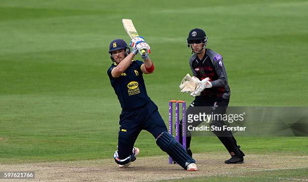 Warwickshire batsman Laurie Evans hits out watched by wicketkeeper Ryan Davies during the Royal London One-Day Cup semi final between Warwickshire...