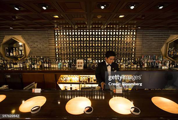 Bartender stands behind the bar at the Old Imperial Bar at the Imperial Hotel in Tokyo, Japan, on Friday, Aug. 19, 2016. Tokyo's Imperial Hotel, the...