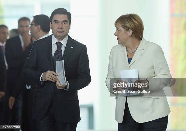 German Chancellor Angela Merkel and Turkmenistan President Gurbanguly Berdymukhamedov arrive to speak to the media following talks at the Chancellery...