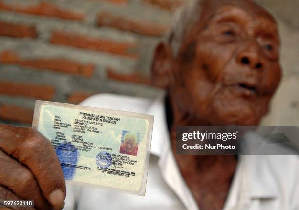 An Indonesian man, named Mbah Gotho, claimed to be 146 years old, is the oldest human in world's history shows his identity card to press members at...