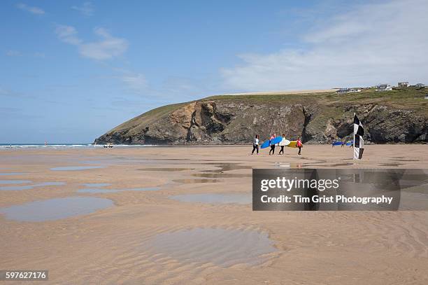 surfers on the beach, mawgan porth, cornwall - mawgan porth fotografías e imágenes de stock