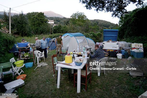 People make use of a temporary camp set up in the hamlet of Saletta on August 24, 2016 in Amatrice, Italy. The region in central Italy was struck by...