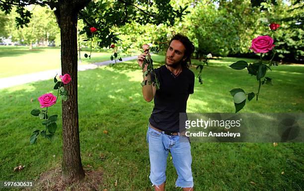 man with floating roses - anatoleya stock pictures, royalty-free photos & images