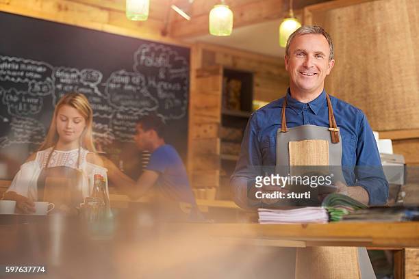 happy coffee shop owner - bookie board stock pictures, royalty-free photos & images