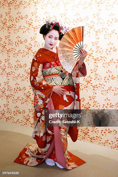 maiko girl posing with japanese folding fan - geisha in training stock pictures, royalty-free photos & images