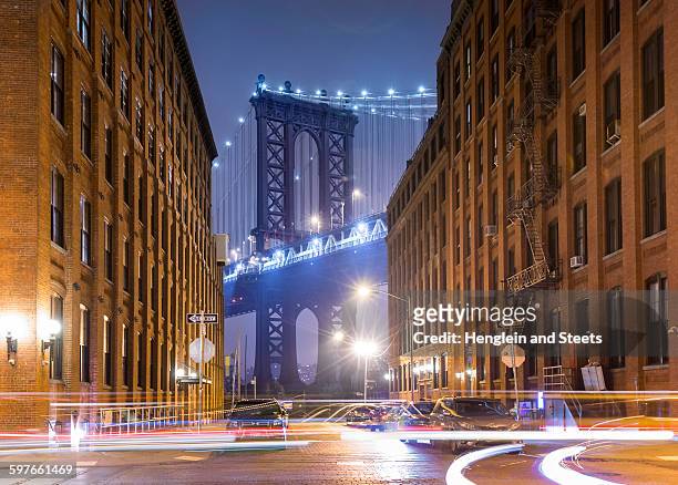 manhattan bridge and city apartments at night, new york, usa - lower east side manhattan stock pictures, royalty-free photos & images