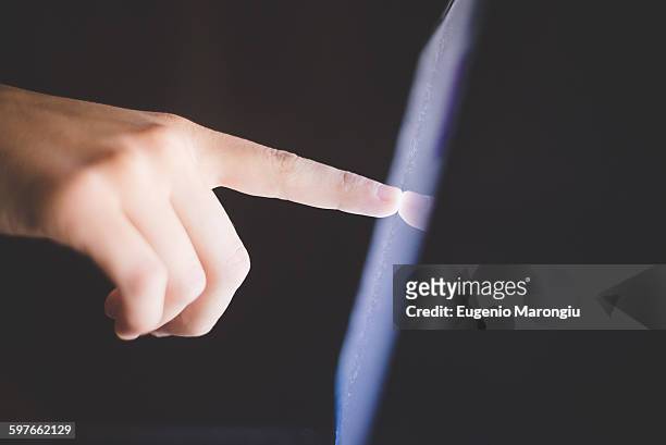 side view of hand pointing at computer screen - human finger stock pictures, royalty-free photos & images