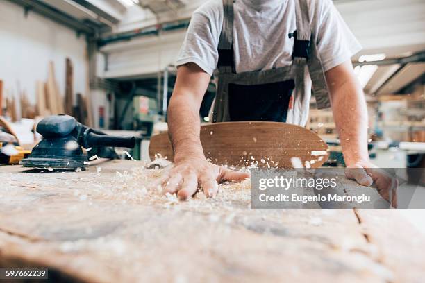 carpenter and wood shavings from skateboard - wood shaving stock pictures, royalty-free photos & images