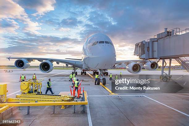 ground crew attending to a380 aircraft at airport - paso elevado fotografías e imágenes de stock