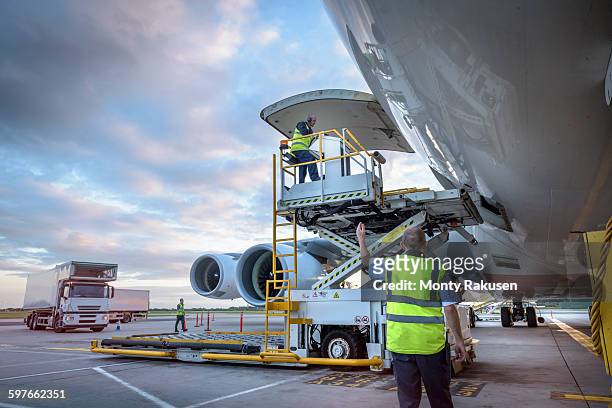 ground crew attending to a380 aircraft with freight loader at airport - airport worker stock pictures, royalty-free photos & images