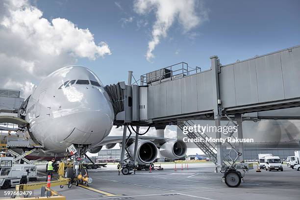 ground crew inspecting a380 aircraft on stand in airport - passenger boarding bridge stock pictures, royalty-free photos & images