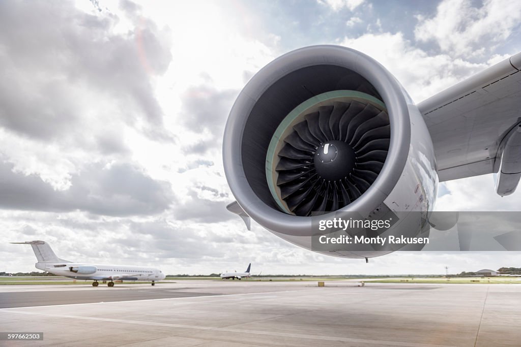 View of A380 aircraft jet engine and planes on runway