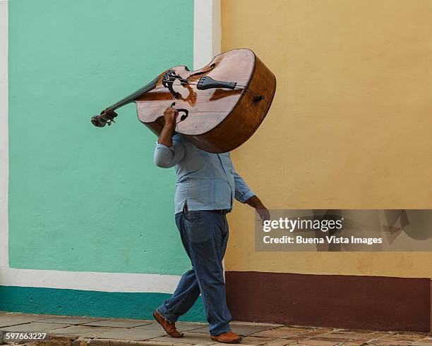 cuba. man carrying double bass. - musikinstrument bildbanksfoton och bilder