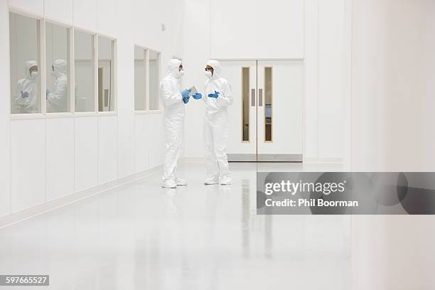 scientists in discussion - man in white suit stock-fotos und bilder