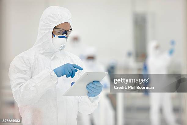 scientists working in laboratory - clean suit stock pictures, royalty-free photos & images