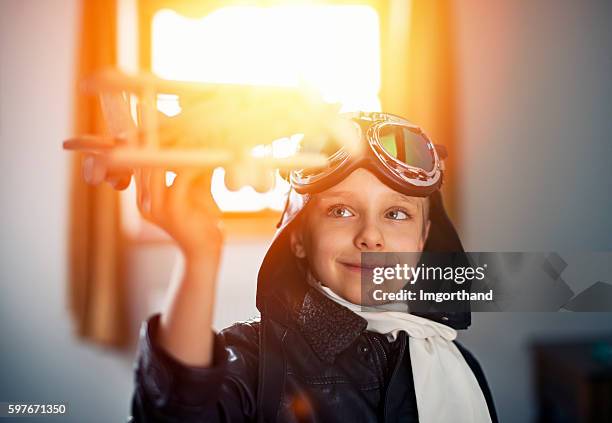 little boy playing with toy plane - kid pilot stock pictures, royalty-free photos & images