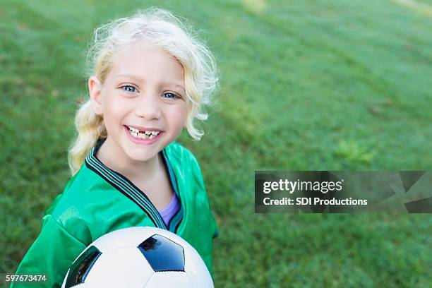 sweet soccer girl with missing teeth - achievement gap stock pictures, royalty-free photos & images