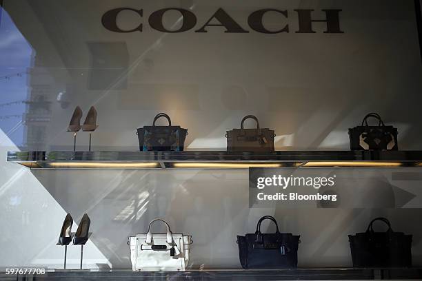 Handbags and shoes are displayed for sale inside a Coach Inc. Store at the Easton Town Center shopping mall in Columbus, Ohio, U.S., on Tuesday, Aug....