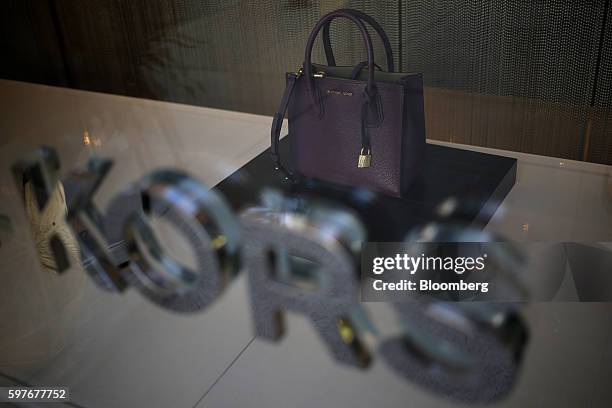 Handbag is displayed in the window of a Michael Kors Holdings Ltd. Store at the Easton Town Center shopping mall in Columbus, Ohio, U.S., on Tuesday,...
