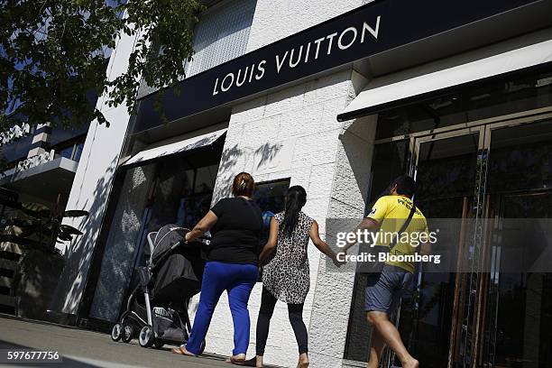 Pedestrians pass a LVMH Moet Hennessy Louis Vuitton SE store at the Easton Town Center shopping mall in Columbus, Ohio, U.S., on Tuesday, Aug. 23,...