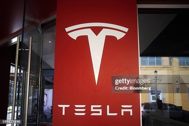 Signage is displayed outside a Tesla Motors Inc. Store at the Easton Town Center shopping mall in Columbus, Ohio, U.S., on Tuesday, Aug. 23, 2016....