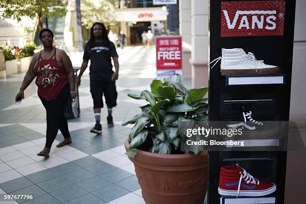 Pedestrians pass in front of a Pacific Sunwear of California Inc. Store at the Easton Town Center shopping mall in Columbus, Ohio, U.S., on Tuesday,...